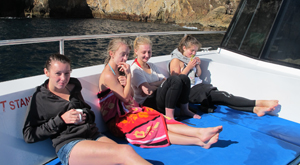 Enjoying a hot chocolate on the boat trip to the Poor Knights Marine Reserve. Student tour for Marine Studies biology students.